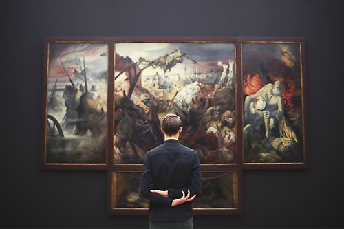 Man looking at a painting at a museum