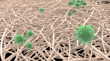 The illustration shows the nanofibers in white and the virus in green. 