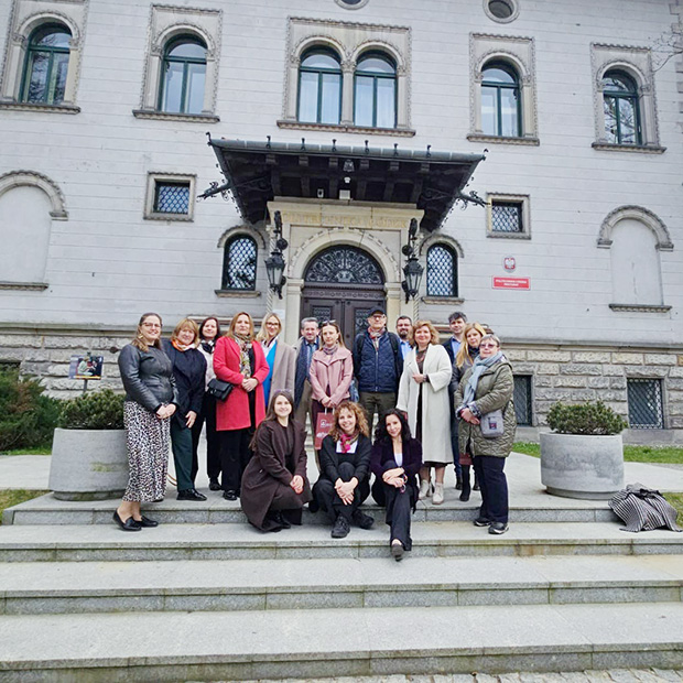 A group of people standing outside a stone building