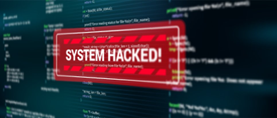 The words “System hacked” written at the top of a computer screen with programming code.