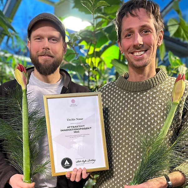 Porträttbild av Simon Hultby och Linus Söderquist med diplom och blommor i Tropiska växthuset
