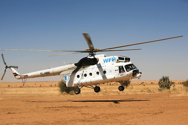 A UNICEF helicopter landing on desert 