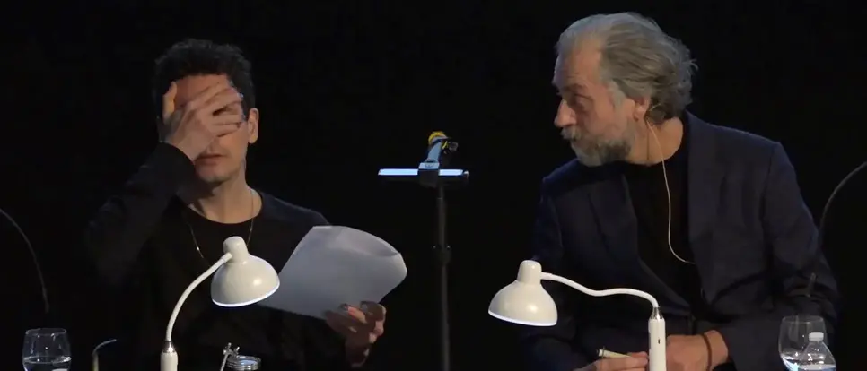Two men at a workbench.
