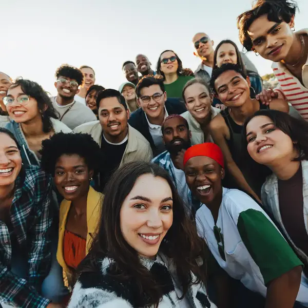 A group of people are looking into the camera from close up.