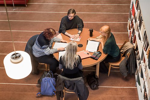 Students studying together around a table.
