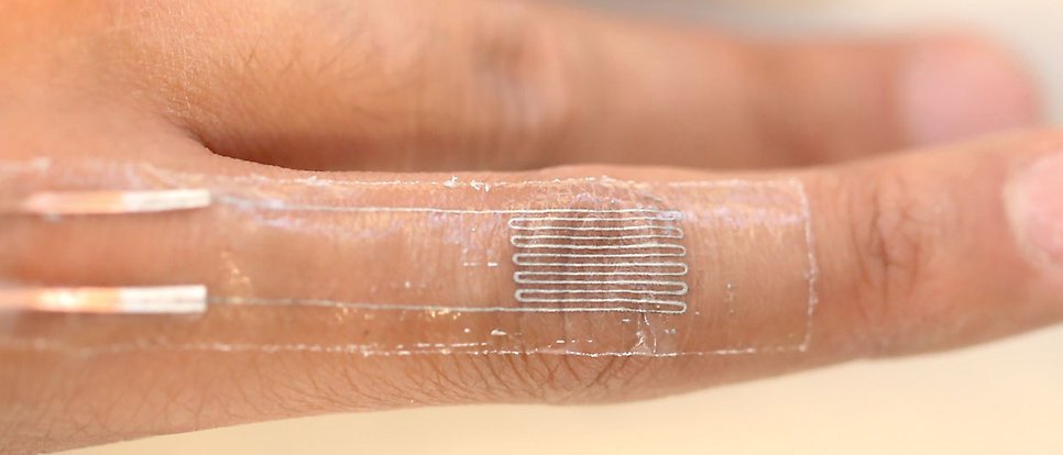 Finger with stretchable electronic patch.