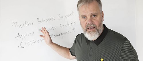 Martin Kalberg standing by a white board.