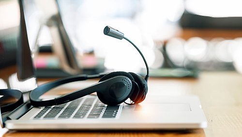 Headphones on the keyboard of a laptop.