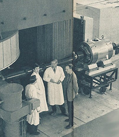  a historical picture of the cyclotron with staff in front